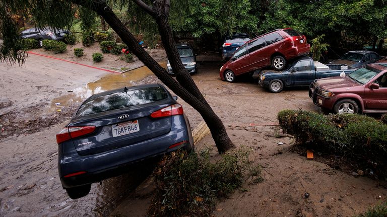 Damage is shown after a heavy rain storm causes a small river to overflow into a neighborhood in San Diego, California