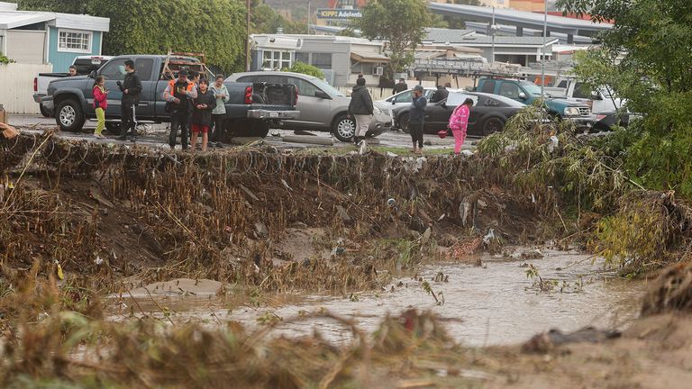 Damage is shown after a heavy rain storm causes a small river to overflow into a neighborhood in San Diego, California 