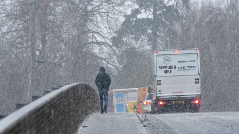 A pedestrian crosses a bridge during a snow shower near Maidstone in Kent. Sleet and snow showers have been forecast for parts of the country on Monday as some regions are still trying to grapple with flooding following intense rainfall. Picture date: Monday January 8, 2024.