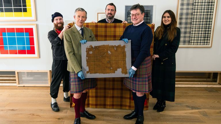EMBARGOED TO 0001 MONDAY JANUARY 22..Undated handout photo issued by House of Edgar of Peter MacDonald, Head of Research & Collections, The Scottish Tartans Authority (left) and John McLeish, Chair, The Scottish Tartans Authority holding a piece of the original Glen Affric Tartan in front of  the newly recreated tartan.  Experts have recreated the oldest-known piece of tartan ever found, which was buried for centuries. The Glen Affric Tartan was discovered around 40 years ago in a peat bog and underwent rigorous testing by the Scottish Tartans Authority last year to confirm it was the oldest surviving piece of tartan. Manufacturer and distributor of tartan fabrics, the House of Edgar, recreated the tartan under the guidance of tartan historian Peter Macdonald to recreate the Glen Affric for people to wear. Issue date: Monday January 22, 2024. PA Photo. See PA story HERITAGE Tartan. Photo credit should read: Alan Richardson /House of Edgar/V&A/PA Wire ..NOTE TO EDITORS: This handout photo may only be used in for editorial reporting purposes for the contemporaneous illustration of events, things or the people in the image or facts mentioned in the caption. Reuse of the picture may require further permission from the copyright holder. .
