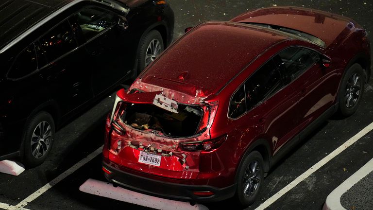 A damaged vehicle is seen in the parking lot of the Sandman Signature hotel following an explosion, Monday, Jan. 8, 2024, in Fort Worth, Texas. (AP Photo/Julio Cortez)