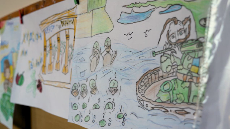 The image, drawn by a child, is among a line of pictures, including of jets, tanks and corpses, that illustrates Ukraine&#39;s lost childhood after almost two years of full-scale war.

