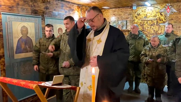 A Russian priest conducts an Orthodox Christmas service for soldiers in Ukraine. Pic: AP