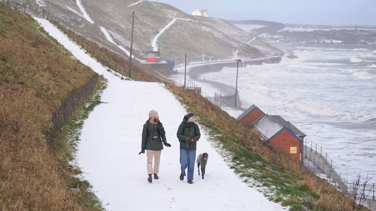 Snowy conditions on Whitby seafront in Yorkshire. The UK will remain in a cold snap until the weekend with freezing temperatures set to plummet even further across much of the country. Picture date: Thursday January 18, 2024. PA Photo. Much of the UK endured temperatures below freezing overnight, with preliminary data from the Met Office indicating the mercury fell to as low as minus 11C in England and minus 10C in Scotland. See PA story WEATHER Cold. Photo credit should read: Danny Lawson/PA Wire