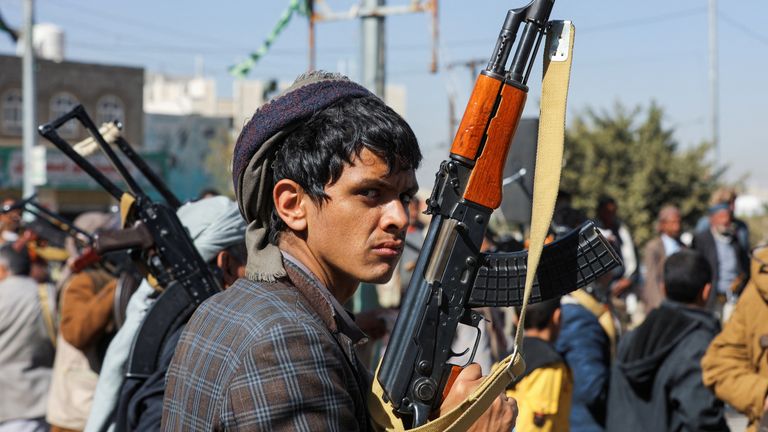 A newly recruited Houthi fighter looks on during a ceremony at the end of his training in Sanaa, Yemen