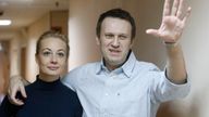 Alexei Navalny gestures with his wife Yulia before a court hearing in Moscow in  2014.
Pic: AP