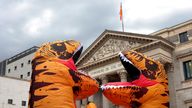 A group of people belonging to Ecologists in Action demonstrate in front of the Spanish parliament with a performance of an inflatable dinosaur TCE-REX that represents the Energy Charter Treaty to which Spain and 52 other countries belonged. Europe and Asia and incompatible with the objectives of the Paris Agreement. They accompanied him with a choreography together with three people dressed as dinosaurs. Pic: AP