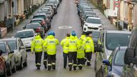 Members of HM Coastguard Search and Rescue walk along a road after homes were evacuated.
Pic PA