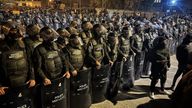 Riot police at the scene following a US drone strike in Baghdad which killed three members of the powerful Kataib Hezbollah militia. Pic: Sky News screengrab.