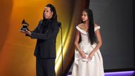 Jay-Z, left, accepts the Dr. Dre Global Impact Award as daughter Blue Ivy Carter, looks on during the 66th annual Grammy Awards on Sunday, Feb. 4, 2024, in Los Angeles. (AP Photo/Chris Pizzello)