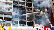 Firefighters work at a site of a building damaged during a Russian missile strike in Kyiv.
Pic: Reuters