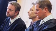 Christian B (middle) with his lawyers. Pic: Reuters