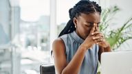 iStock image. Woman stressed at work for Money blog