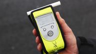 A police officer holding a breathalyser at the launch of the 2022/23 police winter anti-drink/drug drive operation on Sydenham Road in Belfast. Picture date: Thursday December 1, 2022.
