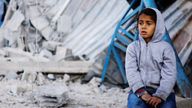 A Palestinian child sits at the site of an Israeli strike on a house in Rafah.
Pic: Reuters