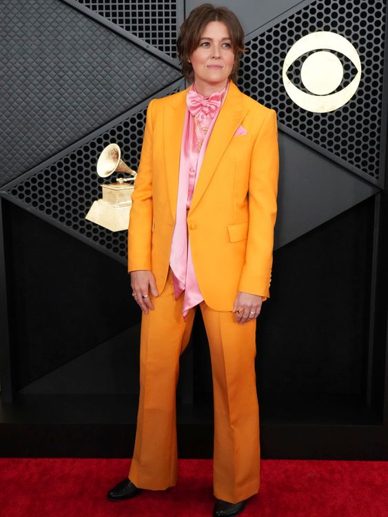 Orange crush: Brandi Carlile pops with a citrus fresh suit. Pic: AP