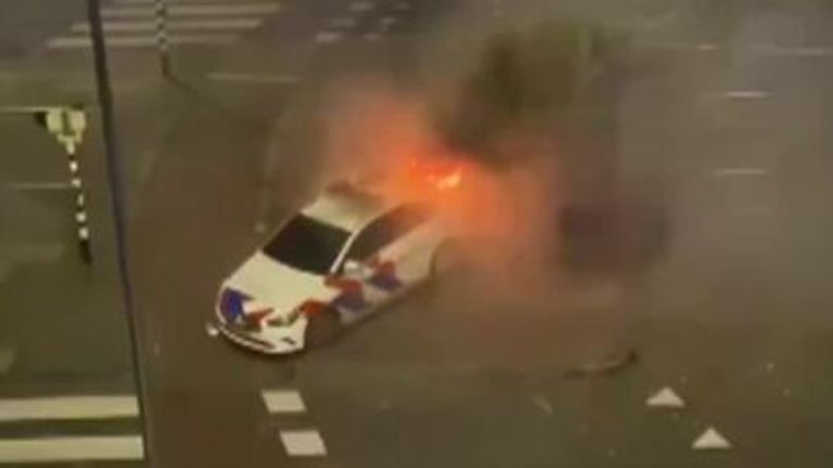 Police cars torched during rioting between rival groups of Eritreans in the Netherlands
