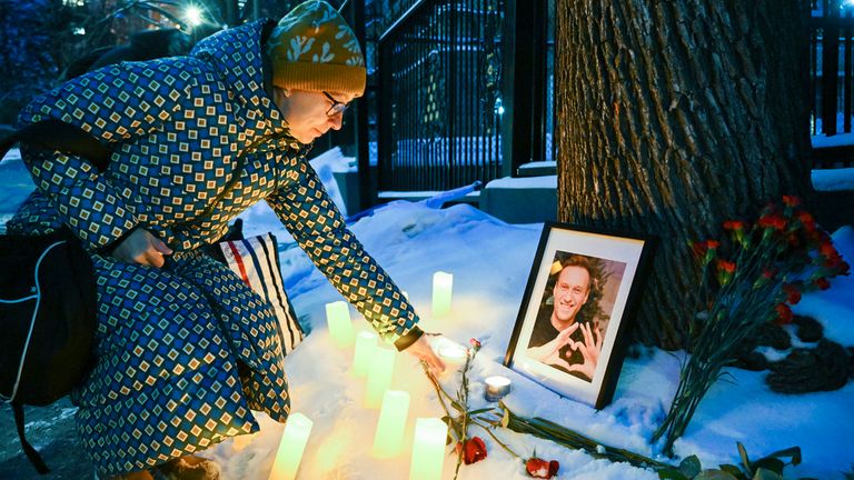 A person places a candle at a makeshift memorial for Alexei Navalny outside the Russian consulate in Montreal, Friday, Feb. 16, 2024. Alexei Navalny, who crusaded against official corruption and staged massive anti-Kremlin protests as President Vladimir Putin...s fiercest foe, has died in the Arctic penal colony where he was serving a 19-year sentence. (Graham Hughes/The Canadian Press via AP)
