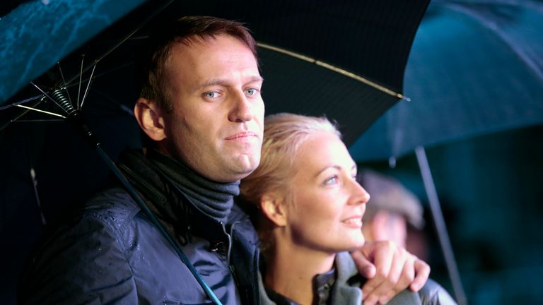 Alexei Navalny and his wife Yulia look on during a support rally in central Moscow in 2013.
Pic: Reuters