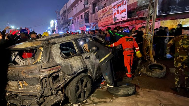 Civil defence members gather at the site of the strike. Pic: AP