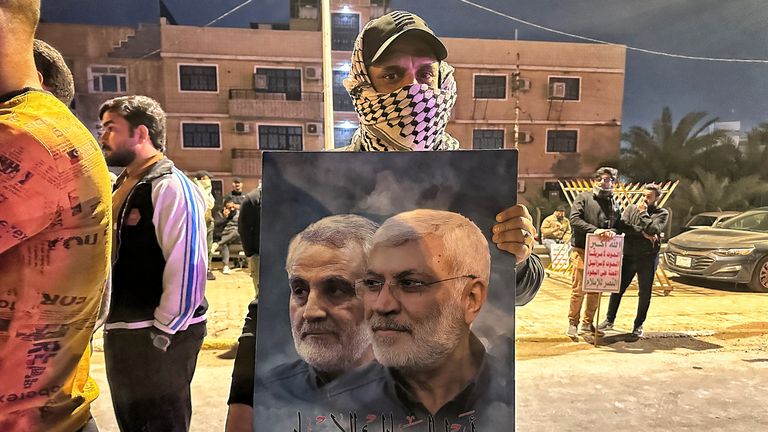 A man holds up a sign of Qassam Suleimani, left, and Abu Mahdi Al Muhandis, after the strike on Baghdad. Pic: Chris Cunningham