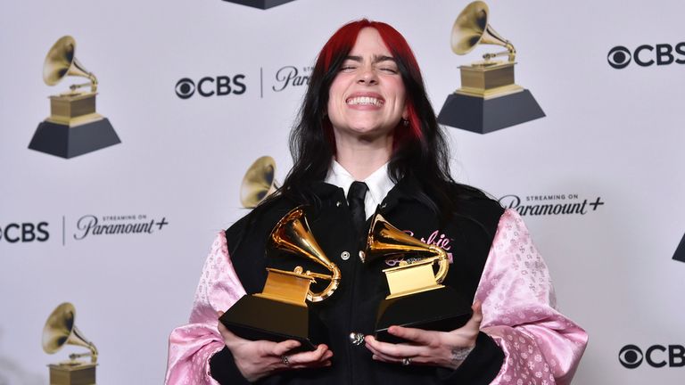 Billie Eilish poses in the press room with the awards for best song written for visual media and song of the year for "What Was I Made For?" from "Barbie the Album" during the 66th annual Grammy Awards on Sunday, Feb. 4, 2024, in Los Angeles. (Photo by Richard Shotwell/Invision/AP)