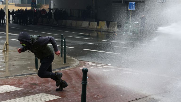 Pic: Reuters
A man runs as water is sprayed during a protest of European farmers over price pressures, taxes and green regulation, on the day of an EU Agriculture Ministers meeting in Brussels, Belgium February 26, 2024. REUTERS/Yves Herman