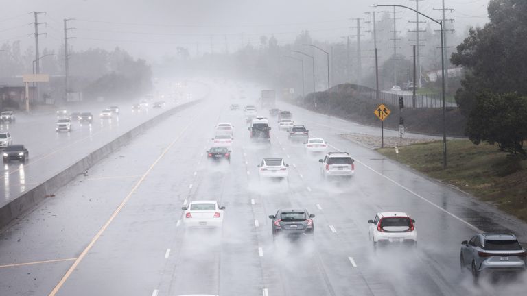 Cars drive in the torrential rain in Agoura Hills, California. Pic: Reuters