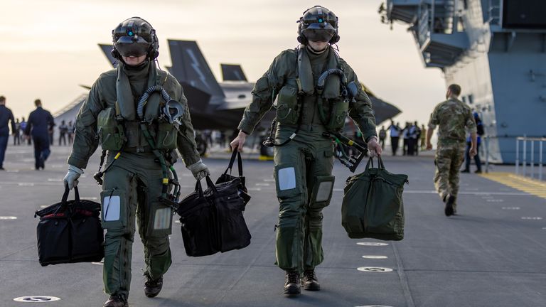 Pic: AS1 Amber Mayall RAF/PA Wire 
Ministry of Defence undated handout photo of pilots of  F-35B Lightning jets on the flight deck of the Royal Navy aircraft carrier HMS Prince of Wales as it heads to join the largest Nato exercise since the Cold War.                         