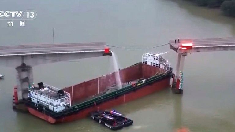 A large hole was left in the bridge after the barge crash. Pic: CCTV/AP