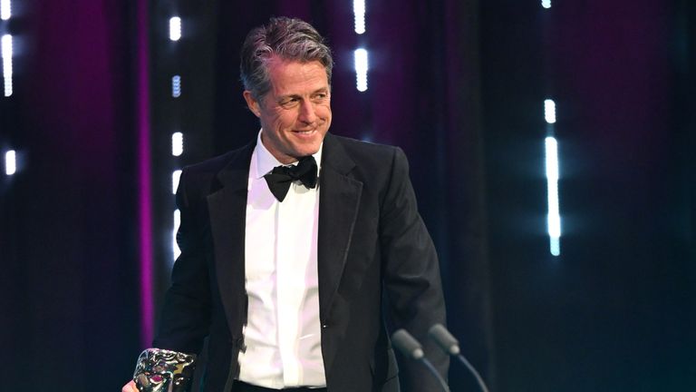 Hugh Grant presents the Best Director Award during the 2024 EE BAFTA Film Awards. Picture: Joe Maher/BAFTA/Getty Images for BAFTA