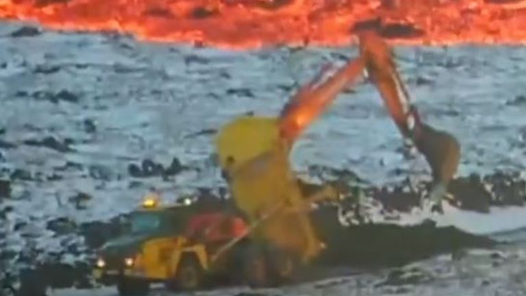 A digger close to a lava flow from a volcanic eruption in Iceland