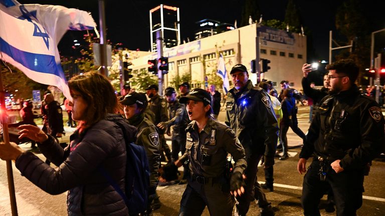 Police officers walk during a protest against Israeli Prime Minister Benjamin Netanyahu&#39;s government, amid the ongoing conflict between Israel and the Palestinian Islamist group Hamas, in Tel Aviv, Israel, February 17, 2024. REUTERS/Dylan Martinez