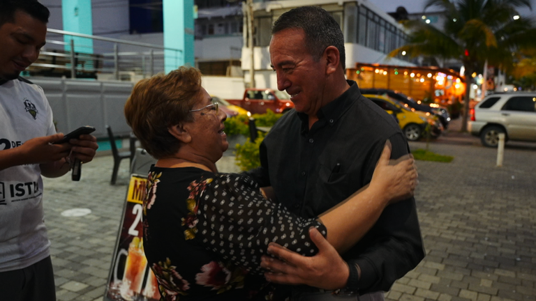 Javier Buitron, governor of Esmeraldas, hugs a woman