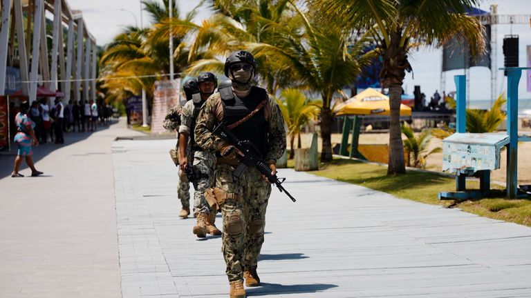 Heavily armed marines patrol the beach