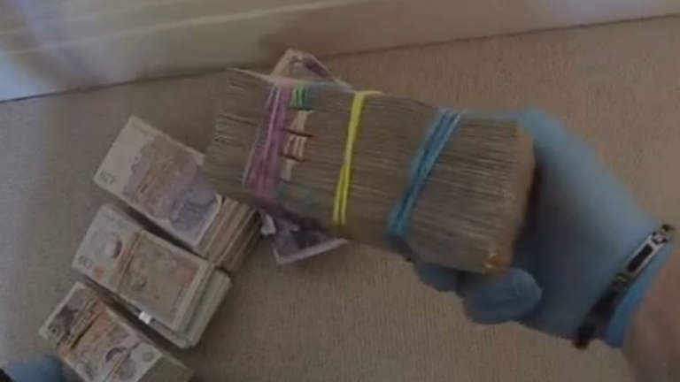 Bundles of cash found in police raids. Pic: CPS