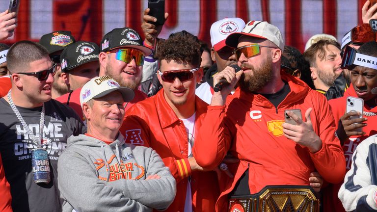 Kansas City Chiefs tight end Travis Kelce, right, serenades the crowd, as Patrick Mahomes, second from right, and teammates look on at the Chiefs&#39; victory rally in Kansas City, Mo., Wednesday, Feb. 14, 2024. The Chiefs defeated the San Francisco 49ers Sunday in the NFL Super Bowl 58 football game. (AP Photo/Reed Hoffmann)