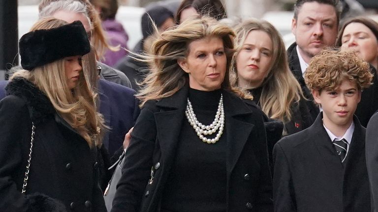 Kate Garraway at the funeral with her daughter Darcey (left) and son Billy (right). Pic: PA