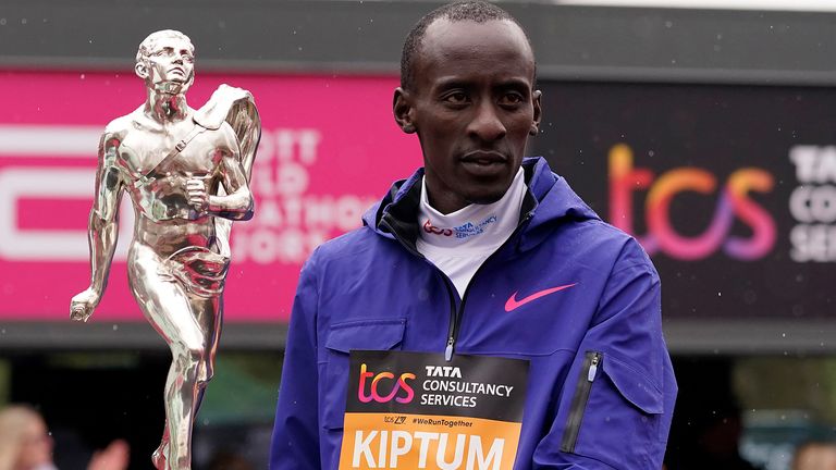 FILE - Men&#39;s race winner Kelvin Kiptum of Kenya holds a trophy together with women&#39;s race winner Sifan Hassan, unseen, of the Netherlands after the London Marathon in London on April 23, 2023. Kiptum was killed along with his coach in a car crash in Kenya late Sunday, Feb. 11, 2024. (AP Photo/Alberto Pezzali, File)