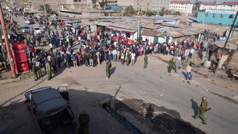 People stand at the scene of the explosion in Nairobi. Pic: AP