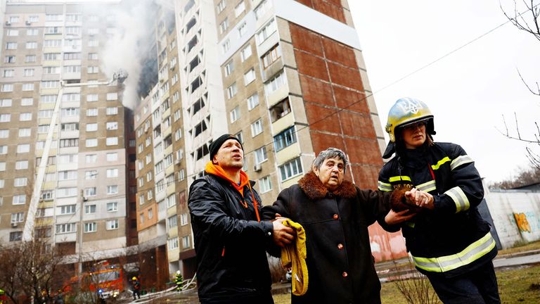 Firefighters work at a site of a building damaged during a Russian missile strike in Kyiv.
Pic: Reuters
