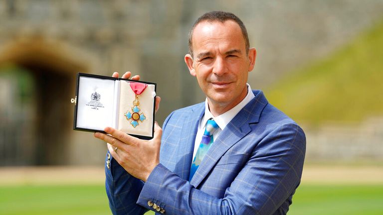 Mr Lewis, pictured with his CBE for services to broadcasting and consumer rights awarded in July 2022 
Pic: Andrew Matthews/Pool Photo via AP