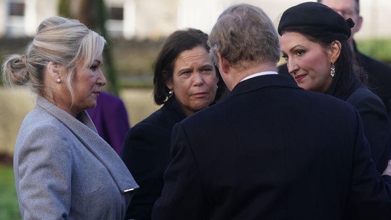 Northern Ireland&#39;s new first minister and her deputy speaking to Sinn Fein president Mary Lou McDonald and former taoiseach Enda Kenny outside the church. Pic: Brian Lawless/PA Wire 