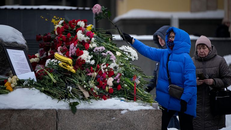 People continue to lay flowers despite the risk. Pic: AP