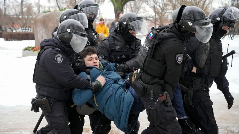 Police detain a man as he wanted to lay flowers paying their last respect to Alexei Navalny at the monument, a large boulder from the Solovetsky islands, where the first camp of the Gulag political prison system was established, in St. Petersburg, Russia on Saturday, Feb. 17, 2024. Russian authorities say that Alexei Navalny, the fiercest foe of Russian President Vladimir Putin who crusaded against official corruption and staged massive anti-Kremlin protests, died in prison. He was 47. (AP Photo
