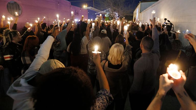 Hundreds of people hold up candles during a candlelight service for Nex Benedict, a nonbinary teenager who died one day after a fight in a high school bathroom, at Point A Gallery, Saturday, Feb. 24, 2024, in Oklahoma City. (Nate Billings/The Oklahoman via AP)
