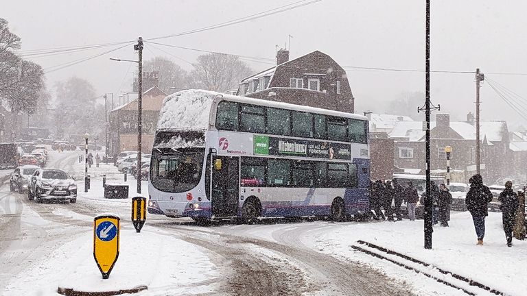 School children pushing a bus in Sheffield.
Pic:Chris Mann/PA 