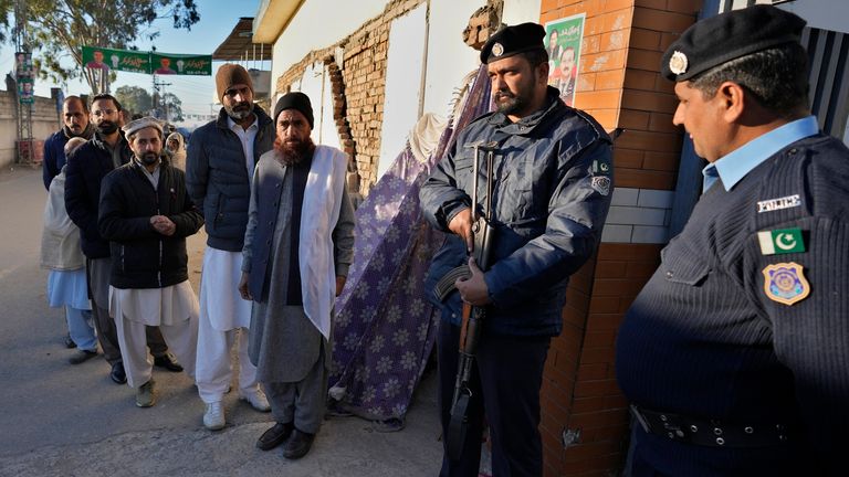 Police officers stand guard outside a polling station in Islamabad, Pakistan. Pic: AP