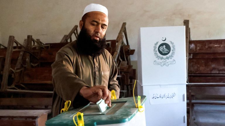 A voter casts his vote during the general election in Karachi, Pakistan.
Pic: Reuters