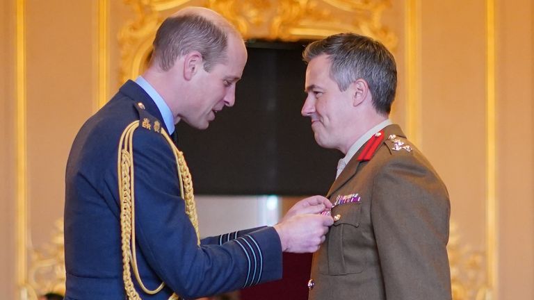 Brigadier Tobias Lambert is made an Officer of the Order of the British Empire by the Prince of Wales